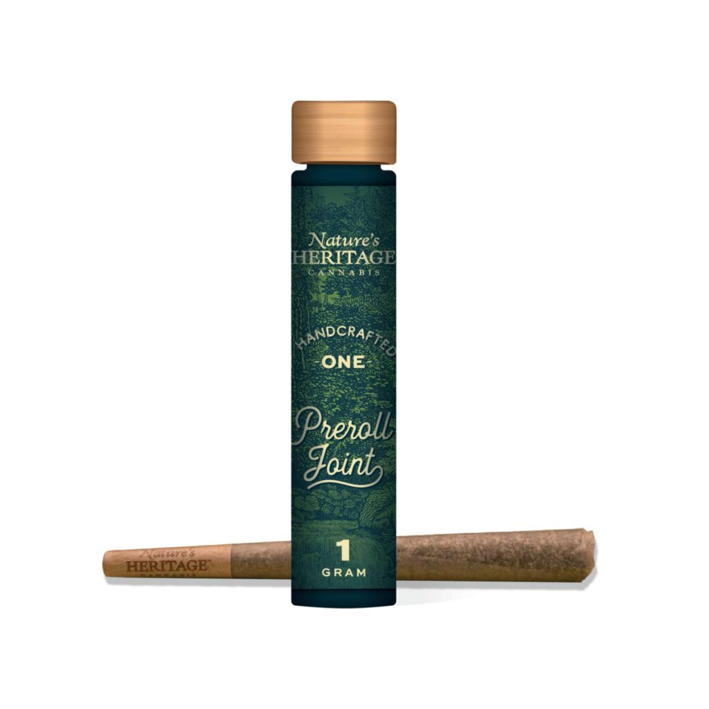 Tall dark green cannabis bottle with a wooden cap, labeled Nature's Heritage Cannabis, 1 gram joint shown beside it on a white background.